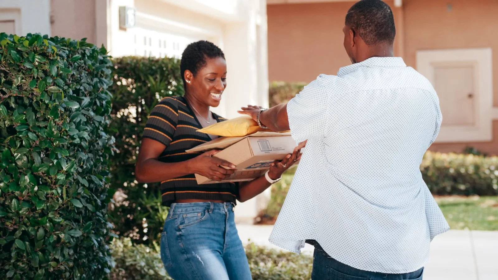 A smiling customer receiving her order at the door