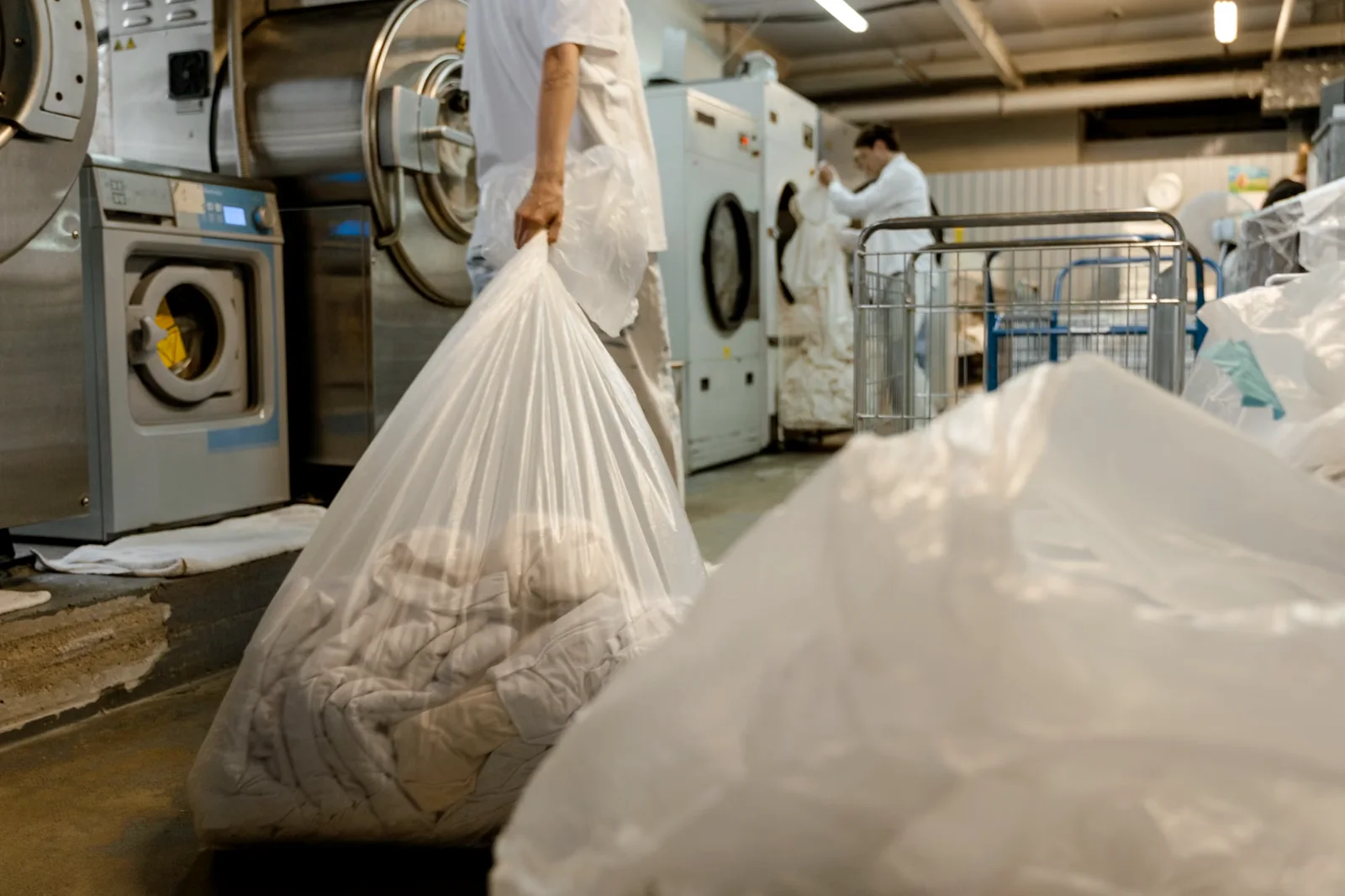 Bags of laundry being moved through a commercial laundry