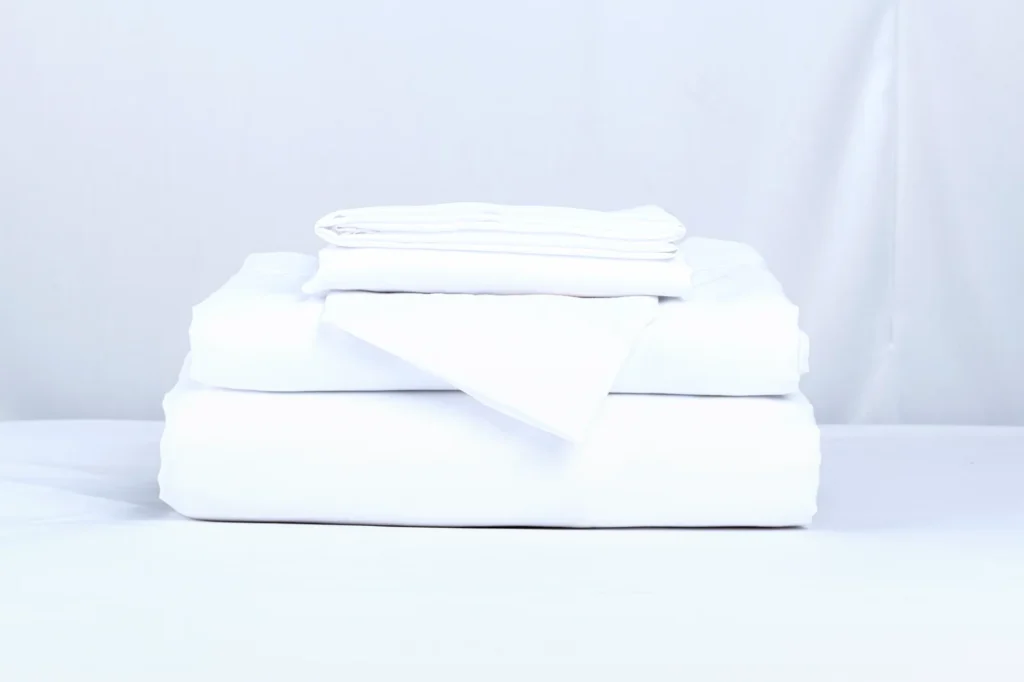 Stack of clean white bed linens